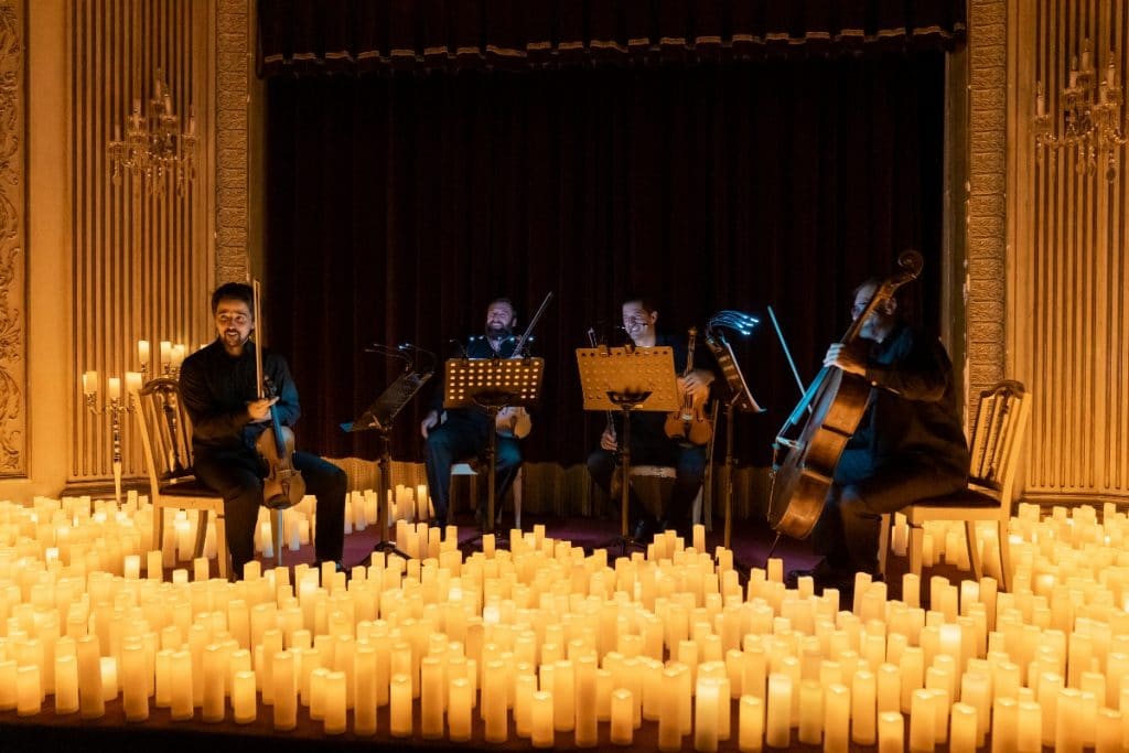Quatuor à cordes entouré de milliers de bougies lors d'un concert Candlelight